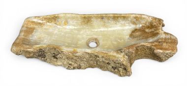 A vintage natural onyx sink of free form with a carved and polished basin and raw live edge. H.11