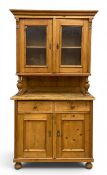 A Victorian pine kitchen cabinet or dresser in two parts with a moulded cornice over two glazed