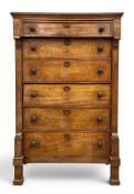 A 19th century Scottish oak chest of six long drawers with overhanging frieze raised on straight