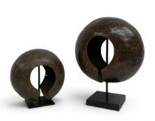Two 20th century African copper currency cuffs raised on museum style mounts from the Mbole