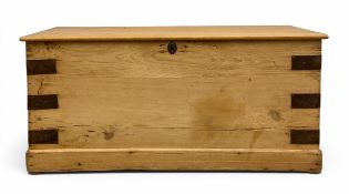 A vintage iron bound pine coffer with hinged plank top raised on a square plinth base. H.43 W.91 D.