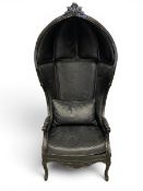 A contemporary Roof Black armchair having a domed porters hood with a carved cresting over the
