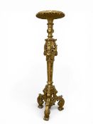 A 19th century Italian giltwood full height torchere stand having a circular gadrooned and marble