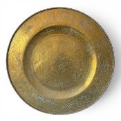 A large and heavy Chinese brass charger with engraved dragons chasing the flaming pearl over a