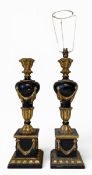 A pair of Louis XVI style carved giltwood and ebonised table lamps of urn form with garland and