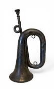 A late 19th century sterling silver hallmarked double loop presentation bugle with a Saxon rim and