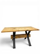 A contemporary Brutalist style dining table with a raw distressed oak plank top raised on industrial