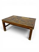 A vintage campaign style brass bound mahogany coffee table with printed top raised on stretchered