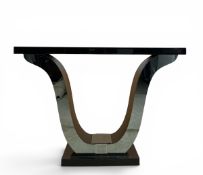 A contemporary Art Deco style console table with black bevelled glass top over the shaped,