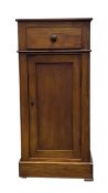A 19th century walnut nightstand or bedside cabinet with single frieze drawer over the panelled