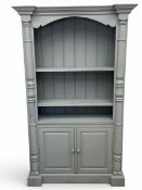 A contemporary 19th century style blue/grey painted bookcase with moulded breakfronted cornice