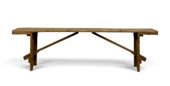A 19th century pine bench with trestle supports. H.50 x W.181 x D.21cm