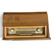 A mid century radiogram in teak case. H.72 W.103cm. (Table turns and lights come on).