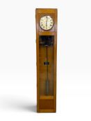 An early 20th century Magneta Master full height wall clock in light oak case with pendulum. H.159 x