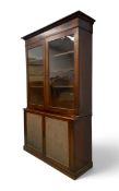 A 19th century mahogany two section library bookcase with glazed upper section enclosing shelves