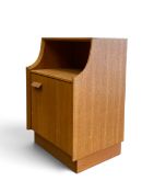 A vintage teak bedside cabinet by G Plan, the open upper section above panel door raised on a plinth