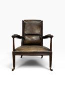 A 19th century mahogany open arm library armchair in studded leather upholstery on fluted tapering