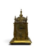 A brass turmchen-uhr tabernacle clock, allover engraved with a domed bell, turrets and coat of