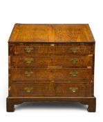 An early to mid 18th century figured walnut bureau with satinwood inlay and a well fitted interior