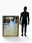 A large wall mirror with bevelled plate in distressed gilt frame. H.132 x W.99cm