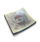 A mid century glazed shallow dish with central geometric motif. H.18cm x W.18cm