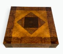 A 1980's vintage Italian low coffee table in a lacquered geometric burr elm finish resting on