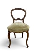 A Victorian walnut balloon back chair with upholstered stuffover seat on slender cabriole