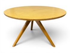 A mid-century beech tripod coffee table with a circular top on flat splayed supports by Victor