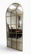 A contemporary full height pier mirror in the form of an arched metal window pane. H.180 x W.80cm