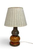 A mid century style Italian table lamp in polychrome slip glaze on a brass base. H.71cm