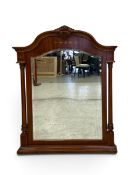 A Continental style walnut and inlaid wall or overmantel mirror with bevelled plate flanked by