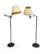 A pair of bronzed metal full height floor standing reading lamps with articulated adjustable arms.
