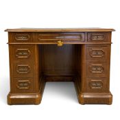 A 19th century walnut pedestal desk of small size with an arrangement of nine drawers on plinth base