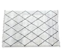 A large contemporary Boho Berber Style carpet with a black diamond linework field over the cream