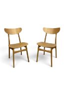 A pair of contemporary light oak John Lewis dining chairs in mid century style with laminated bar