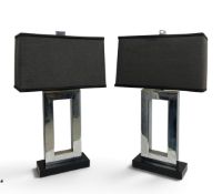 A pair of large Andrew Martin table lamps, chrome and black metal with matching shades, label to