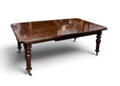 A 19th century mahogany extending dining table, turned legs on brass casters with two extra