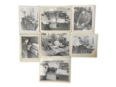 A series of seven photographic prints, black and white, newspaper printing technicians at the