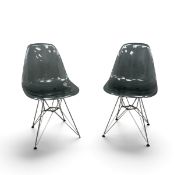 A pair of contemporary chairs in the Eames RE DSW style with stainless steel Eiffel Tower