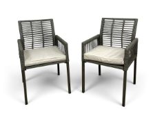 A contemporary pair of wicker armchairs, slatted backs with drop-in seat pads. H.84 x W.51 x D.47cm