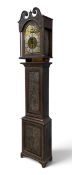 An 18th century carved oak longcase clock with silvered dial and Roman numerals within scrolling