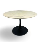 A retro styled dining table with circular faux marble top and black powder coated metal base, in the