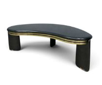 A 1980s vintage shaped top coffee table in a black lacquer finish with brass trim. H.41 x W.128 x