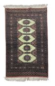 A Bokhara rug with central lozenge medallions within flowerhead design and stylised multiple