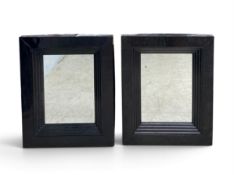 A pair of contemporary wall mirrors with stepped lacquered frames. H.82 x W.67cm. (Some wear and