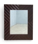 A contemporary wall mirror in a carved teak frame. H.105 x W.85cm.