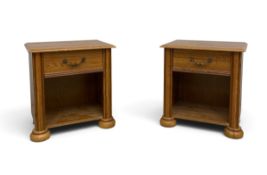 A pair of contemporary oak bedside table cabinets each with a single frieze drawer over an open