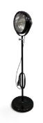 A contemporary floor-standing spotlight, industrial style with adjustable height and swivel light