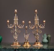 A SET OF THREE CANDELABRA DEPICTING EAGLES WRESTLING SNAKES