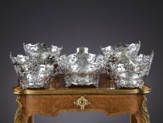 AN IMPRESSIVE SUITE OF SEVEN STERLING SILVER SERVING BASKETS, EARLY 20TH CENTURY